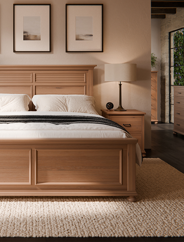 A handcrafted Amish wooden bed frame with a paneled headboard and footboard, styled in a warm, neutral bedroom with matching nightstands and elegant decor. A beautiful example of high-quality bedroom furniture available in Hamptonville.