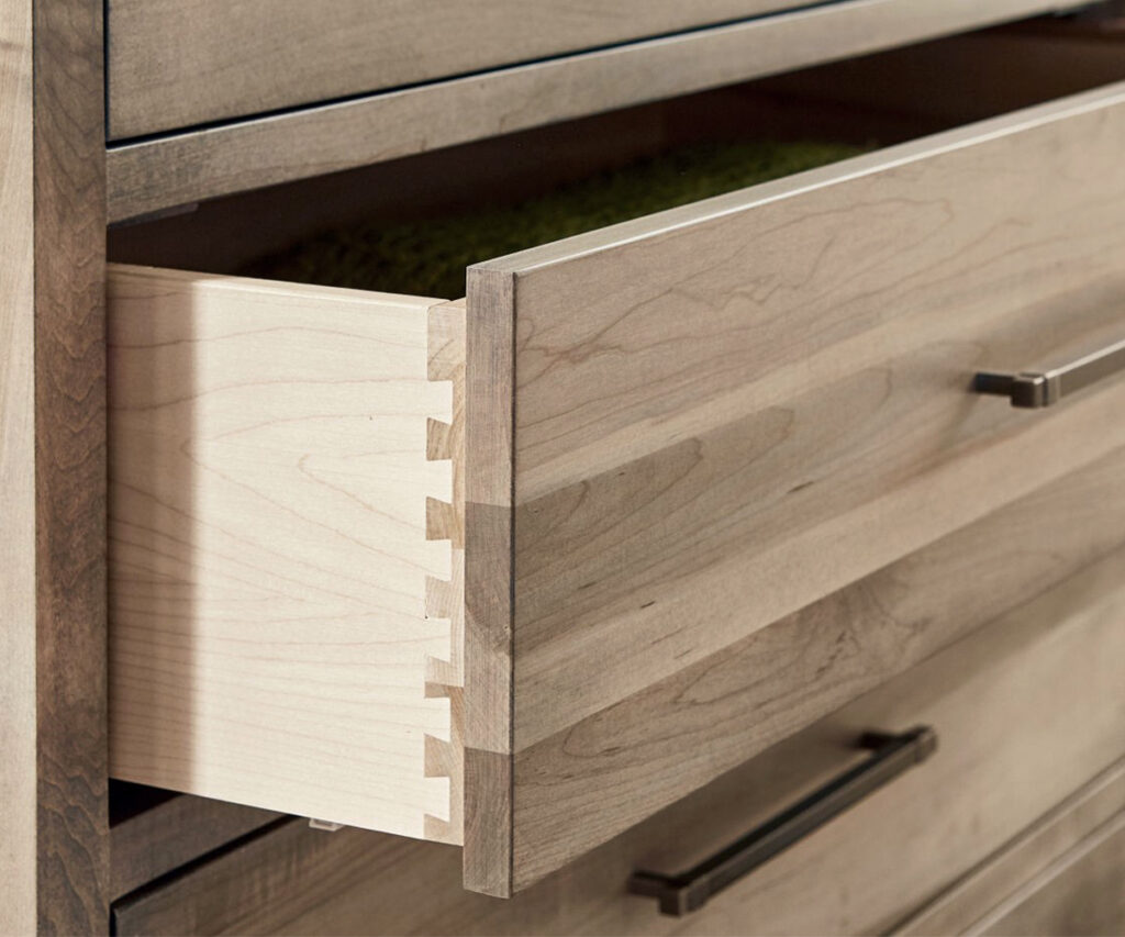 Open drawer showing dovetail joinery in solid wood bedroom furniture