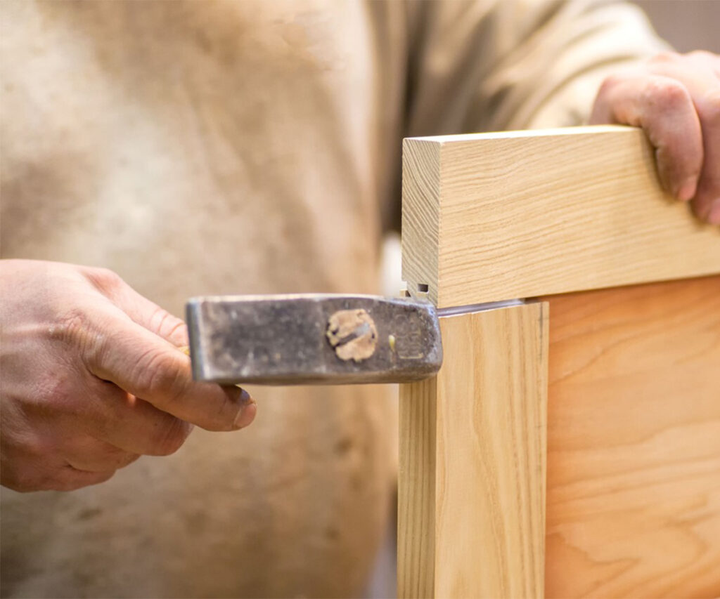 Close-up of mortise and tenon joint assembly in handcrafted wood furniture