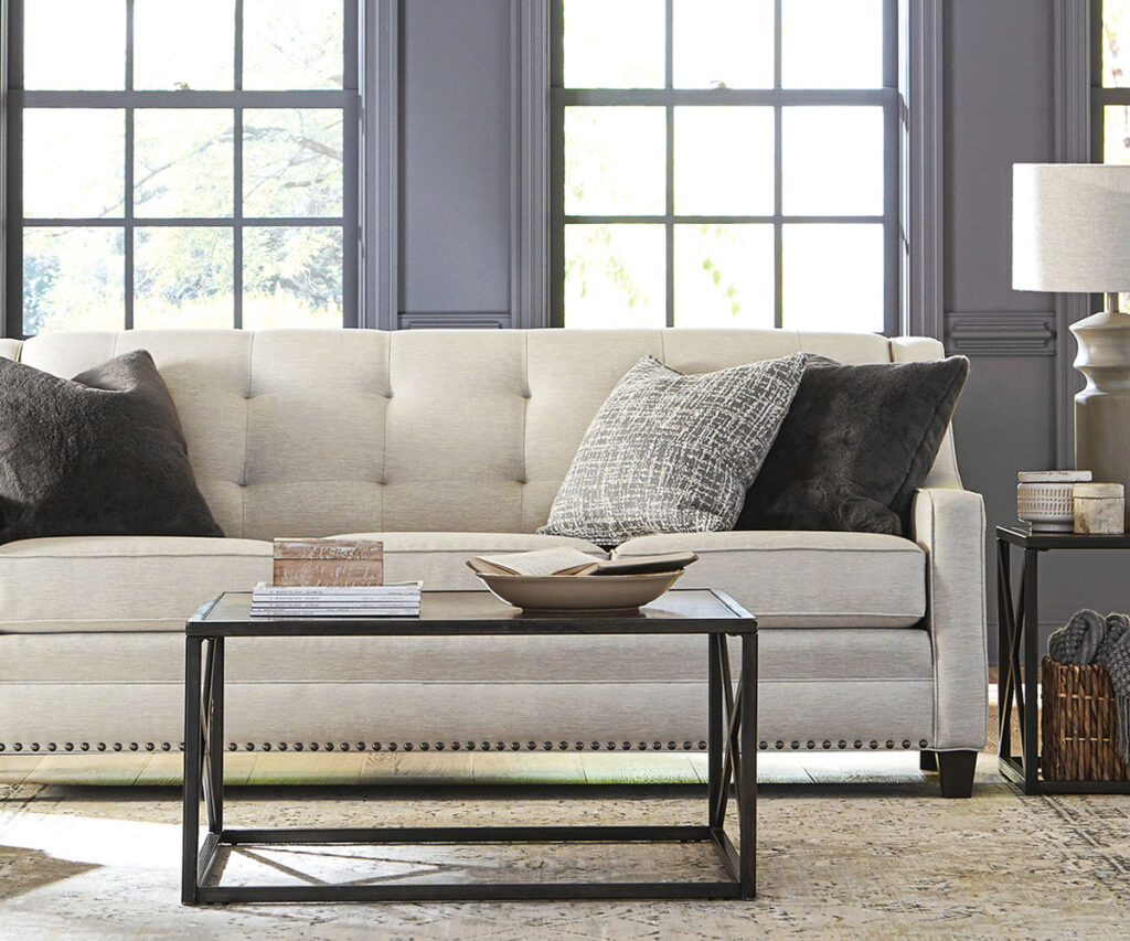 Neutral Smith Brothers sofa with accent pillows and coffee table in bright living room.